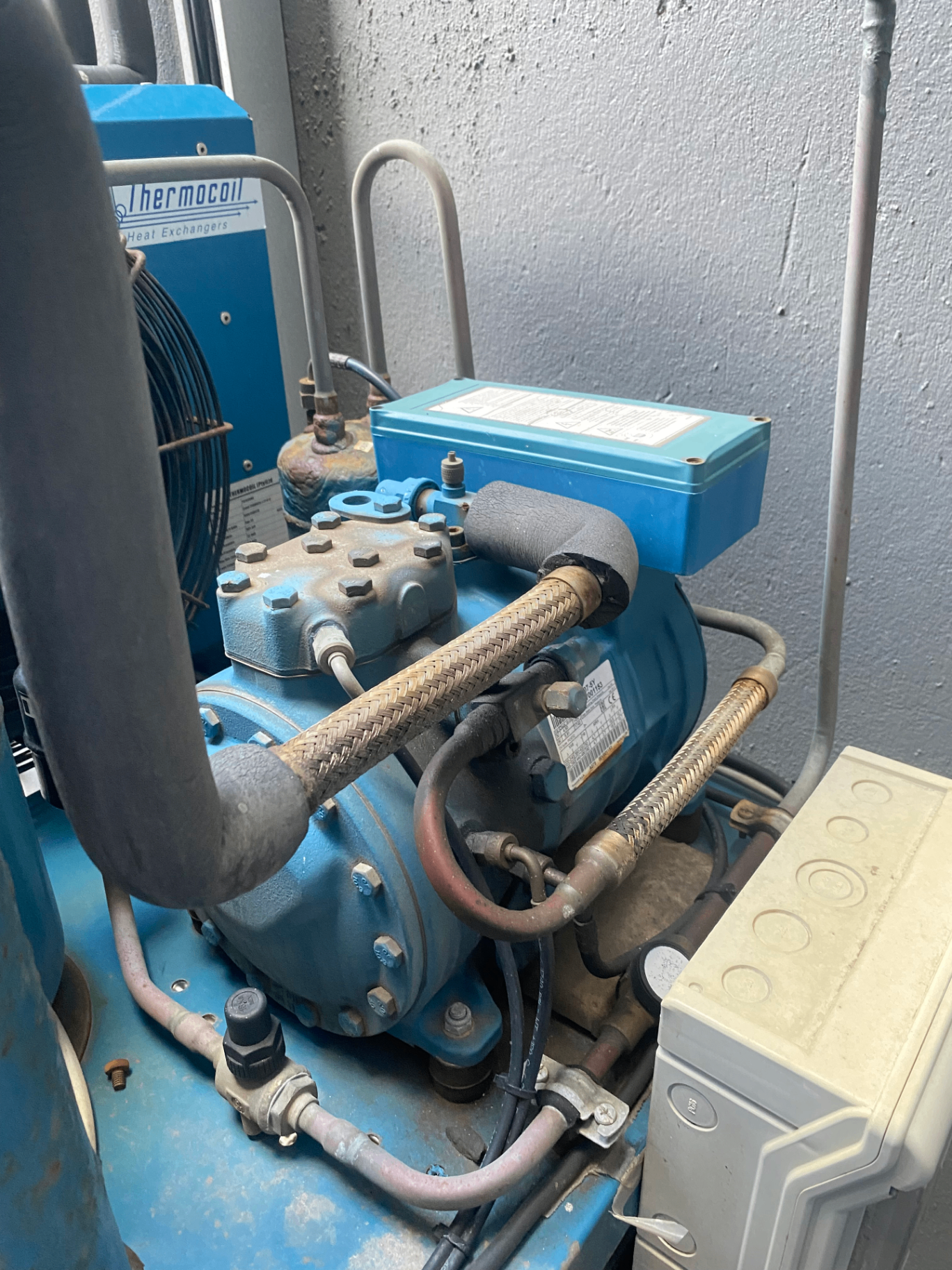 Close-up of refrigeration compressor components during inspection